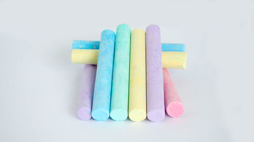 High angle view of multi colored pencils on white background