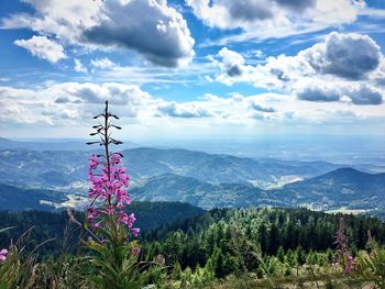 Scenic view of mountains against cloudy sky