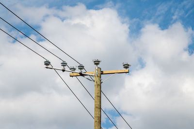 Low angle view of power line against sky