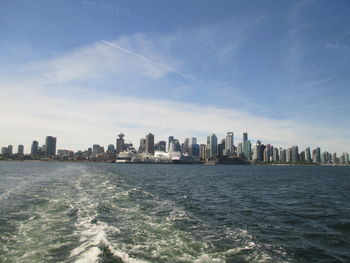 Sea and cityscape against sky