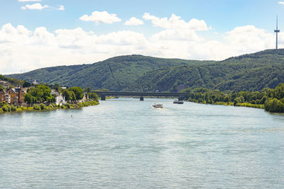 An old, historic city on the banks of the river rhine in western germany, visible barge and bridge.