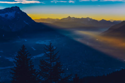 Scenic view of snowcapped mountains against sky during sunset