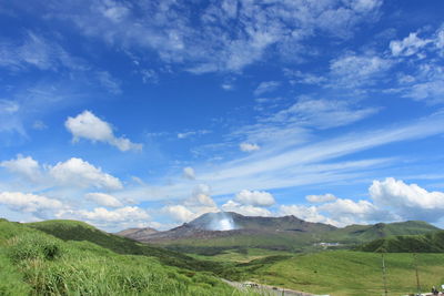 Scenic view of green mountains against sky