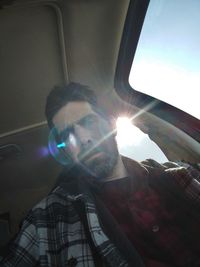 Low angle view of man seen through car windshield