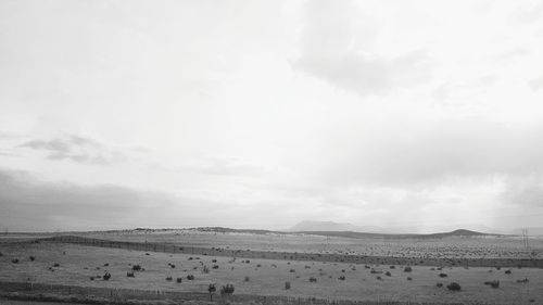 Scenic view of landscape against cloudy sky