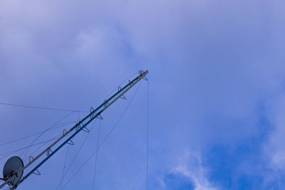 Low angle view of crane against blue sky