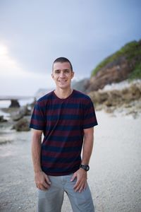 Portrait of smiling man standing at beach