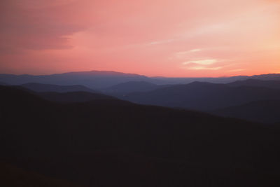 Scenic view of silhouette mountains against sky during sunset