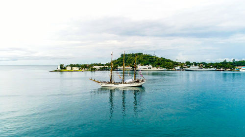 Sailboat in sea against sky