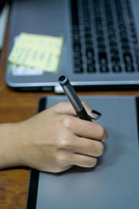 Close-up of hands working on table
