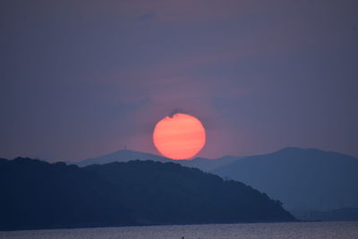 Scenic view of sea against romantic sky at sunset