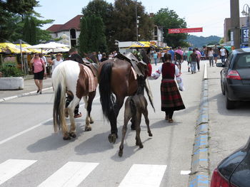 Group of people walking on road in city