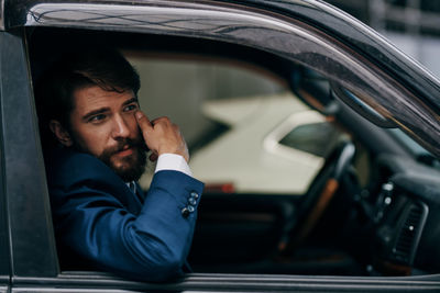 Portrait of young man in car