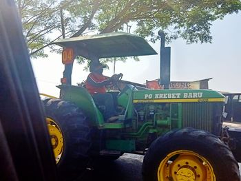 Tractor on field against sky