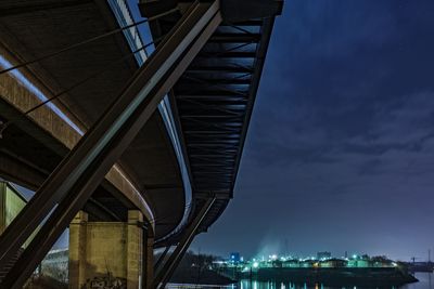 Low angle view of bridge against sky at night