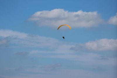 Low angle view of paragliding against sky