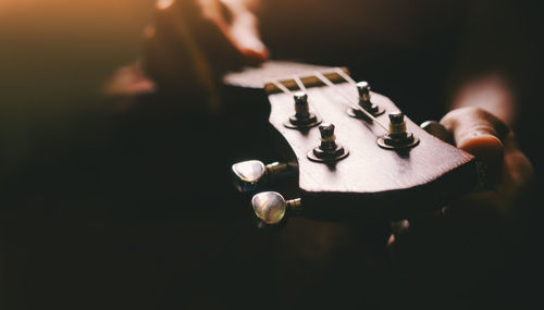 Close-up of man playing guitar