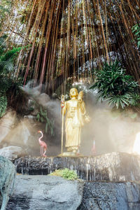 Statue amidst trees at temple