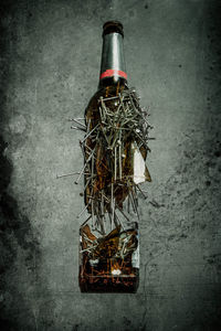 Close-up of old bottle against black background