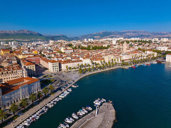 High angle view of townscape by sea against sky