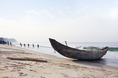 Indian fishermen pull up nets from the sea