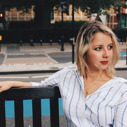 Portrait of a young woman sitting on bench