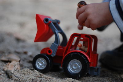 Close-up of hand holding toy car