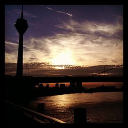 Bridge over river at sunset