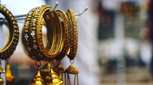 Close-up of bangles hanging for sale at store