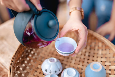 Midsection of woman pouring water