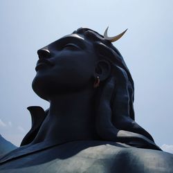 Low angle view of shiva statue against sky