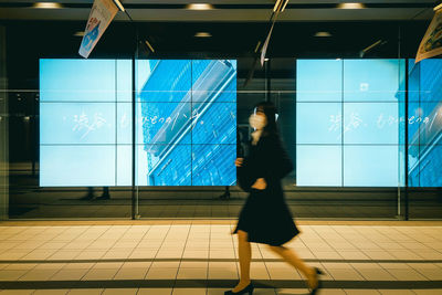Side view of man walking at airport