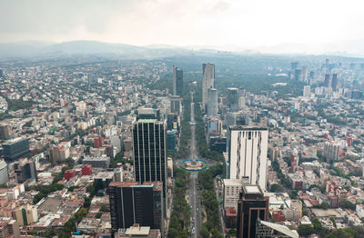 High angle view of modern buildings in city against sky