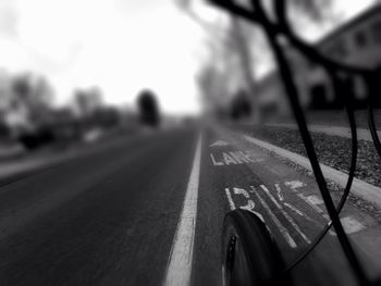 Close-up of car on road against sky