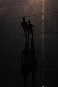 High angle view of silhouette people walking on street at night