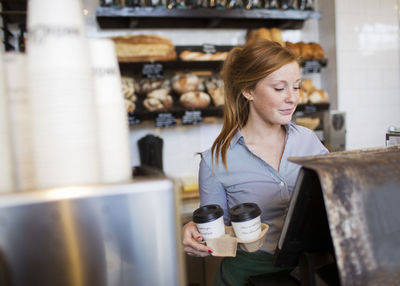 Young woman working in cafe, stockholm, sweden