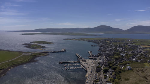 High angle view of sea and city against sky