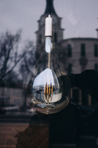 Close-up of wineglass against sky