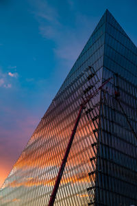 Low angle view of fence against sky during sunset