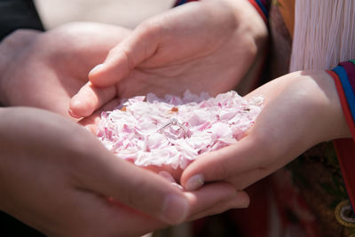 Midsection of woman holding pink hands