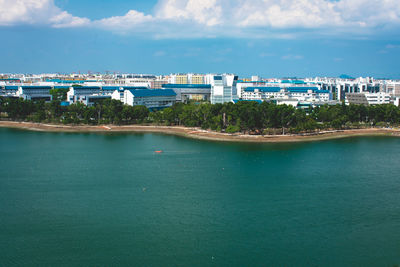 Scenic view of sea by buildings against sky