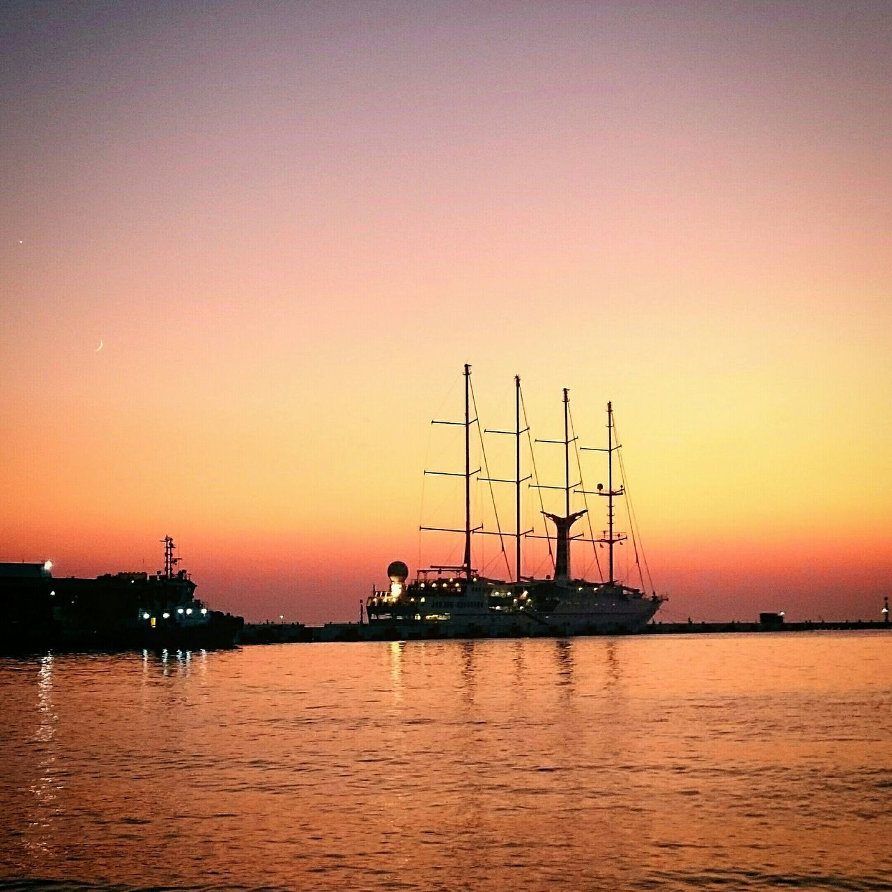 sunset, water, nautical vessel, transportation, boat, orange color, mode of transport, waterfront, sea, tranquil scene, tranquility, beauty in nature, silhouette, scenics, clear sky, reflection, nature, sun, copy space, moored