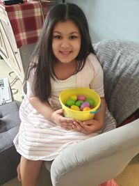 Portrait of a smiling young woman holding food