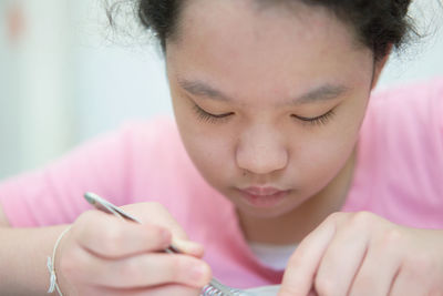 Close-up of young woman using phone