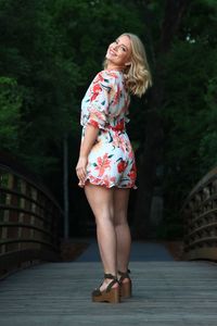 Full length of woman standing on footbridge