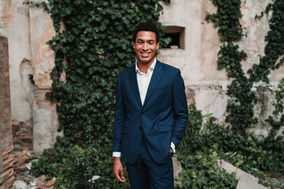 Portrait of a smiling young man standing outdoors