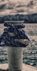 Close-up of rope tied on wooden post