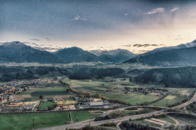 Scenic view of field and mountains against sky