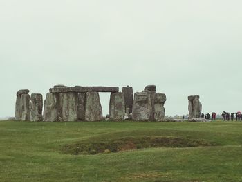 Old ruins on field against sky