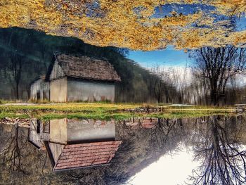 Built structure by lake against trees